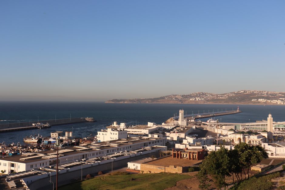 A captivating view of Tanger harbor with the ocean and city in the background.