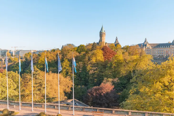 Autumn trees with flags in front of a building